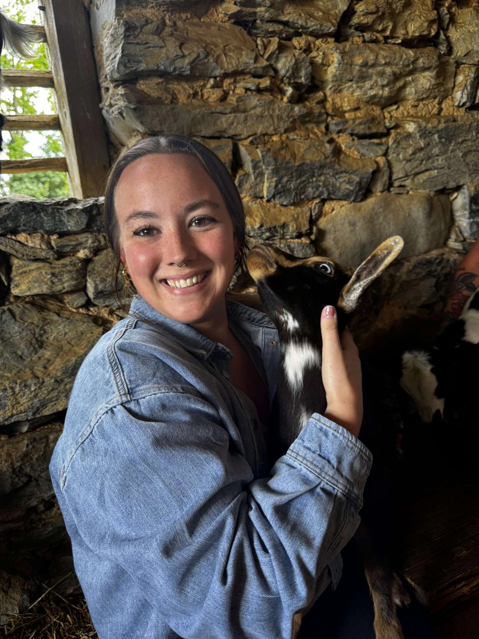 Angel smiling while holding a young goat